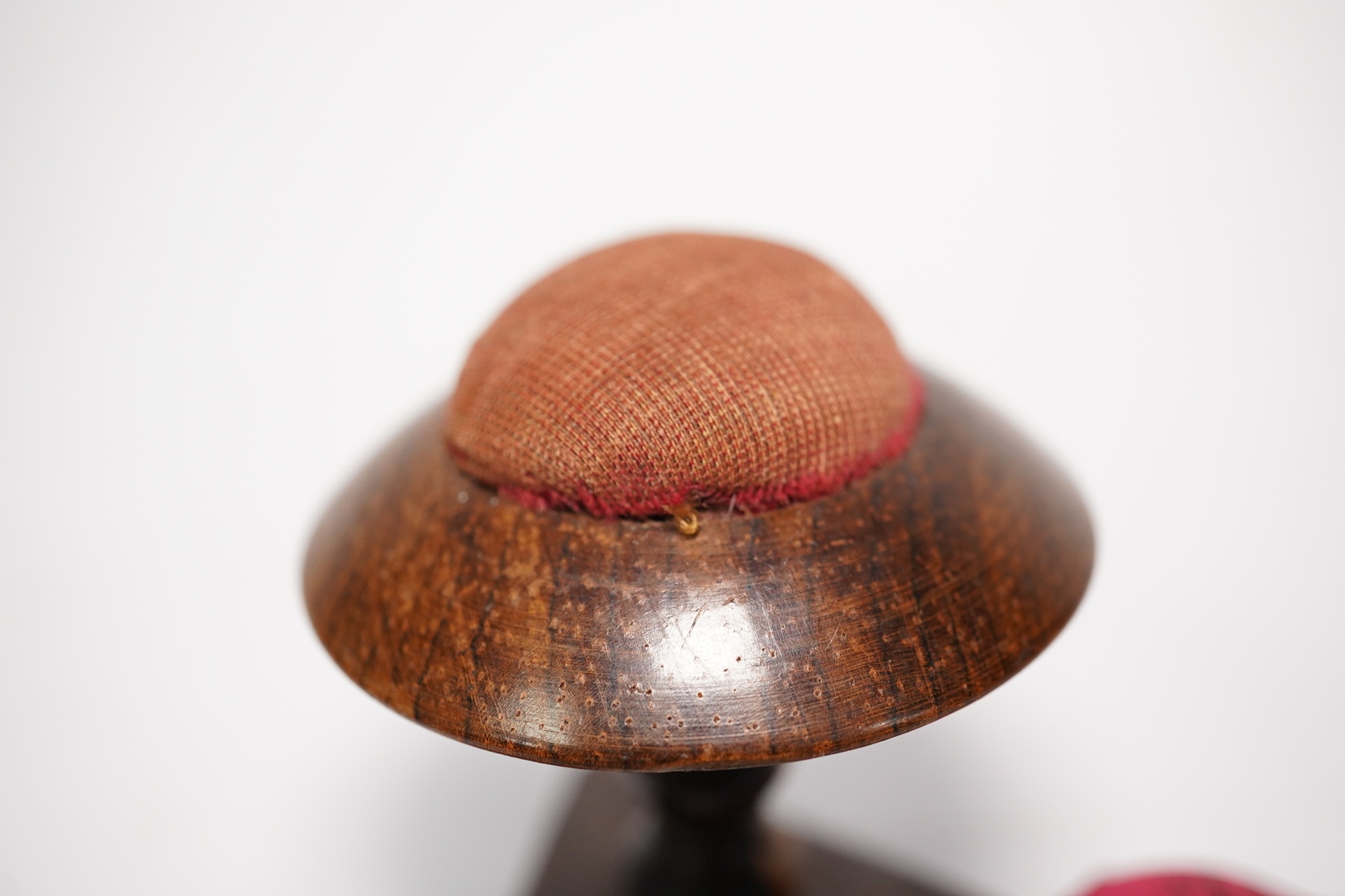 Two early Victorian white metal tape measures and a rosewood miniature 'table' pin cushion. Condition - fair